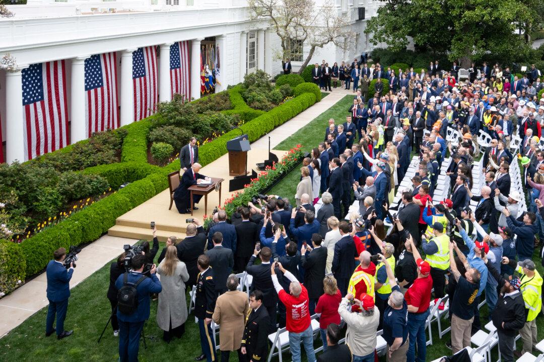 President Donald Trump signs an executive order after remarks on reciprocal tariffs during a Rose Garden event at the White House on April 2, 2025. The Supreme Court is set to review whether the tariffs are authorized under the International Emergency Economic Powers Act. (Saul Loeb/AFP via Getty Images)