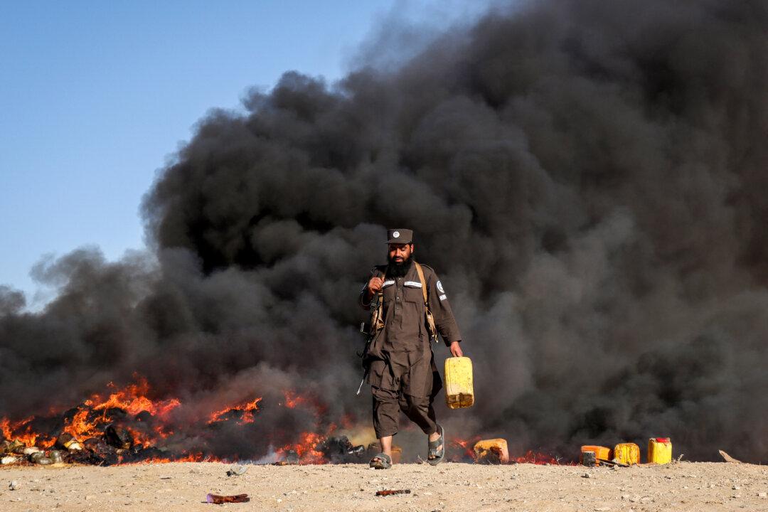 A member of the Taliban security personnel sets ablaze various drugs, on the outskirts of Herat province, Afghanistan, on Nov. 6, 2025. (Mohsen Karimi/AFP via Getty Images)