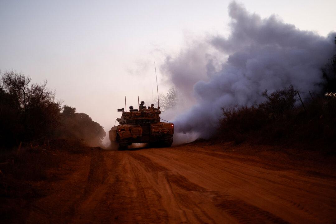Israeli soldiers ride in the army Merkava main battle tank at a position in northern Israel along the border with southern Lebanon, on Nov. 6, 2025. (Jalaa Marey/AFP via Getty Images)