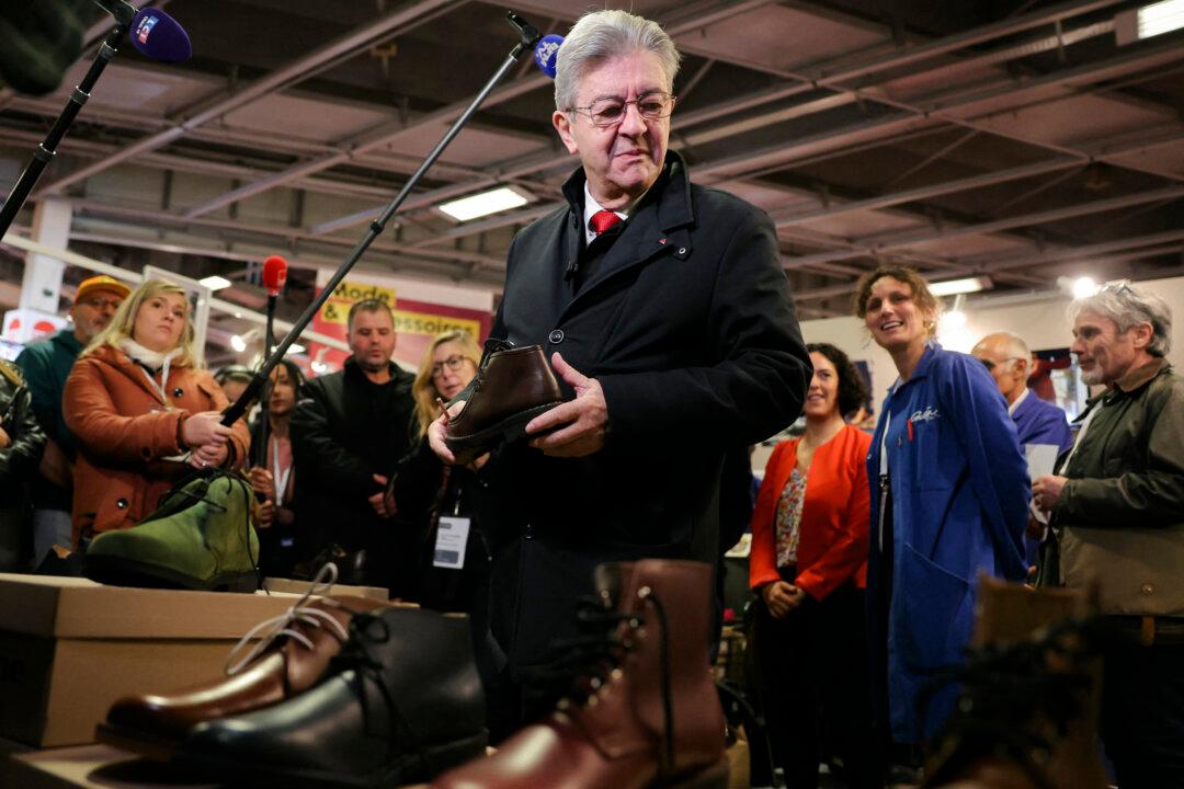 The founder of French left-wing party La France Insoumise, Jean-Luc Melenchon, stands at the French shoemaker Gatine booth during a visit to the “Made in France” trade fair in Porte de Versailles, in Paris on Nov. 7, 2025. (Thomas Samson/AFP via Getty Images)