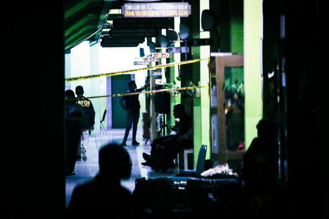 Police officials carry out an on-site investigation following explosions at a school in Jakarta on Nov. 7, 2025. Two blasts on a school campus in Indonesia's capital injured at least 20 people on Nov. 7, authorities said. (Candra/AFP via Getty Images)