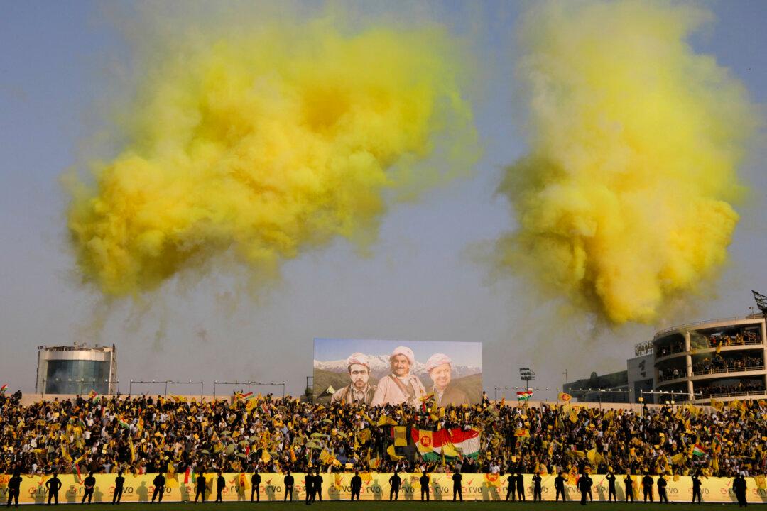 Iraqi Kurds wave flags at a campaign rally for the Kurdistan Democratic Party at the Franso Hariri Stadium in Erbil, Iraq, on Nov. 7, 2025, ahead of the country's parliamentary elections on Nov. 11. At least 25 percent of parliamentary seats must go to women, according to the quota system that also reserves nine seats for minorities. More than 7,700 candidates, nearly a third of whom are women, are running for election in the country of around 46 million people. (Safin Hamid/AFP via Getty Images)