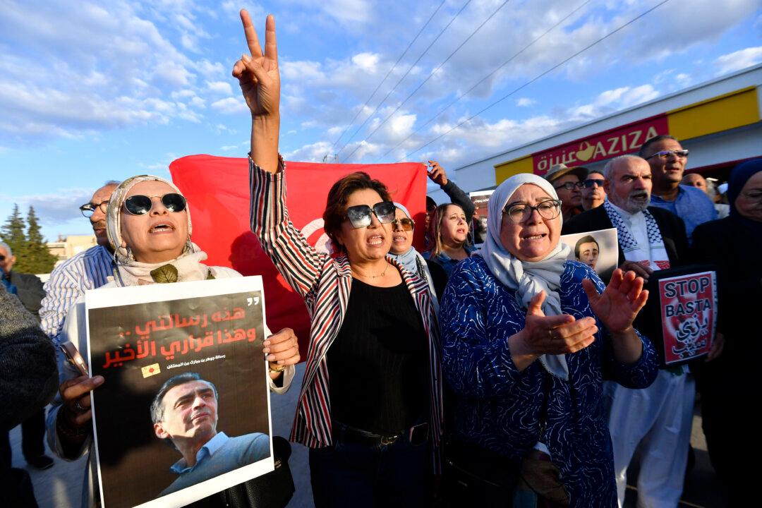 Demonstrators shout slogans outside the Billi prison in the Nabeul region in northeastern Tunisia on Nov. 7, 2025, to demand the release of jailed opposition figure Jawhar Ben Mbarek. The co-founder of the National Salvation Front opposition alliance went on a hunger strike on Oct. 28 to protest his detention, which began in February 2023. (Fethi Belaid/AFP via Getty Images)