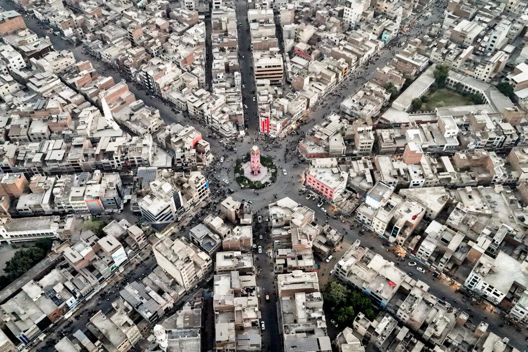 Commuters drive through a clock tower, formerly known as the Lyallpur Clock Tower, in Faisalabad in Pakistan's Punjab province on Nov. 7, 2025. (Aamir Qureshi/AFP via Getty Images)