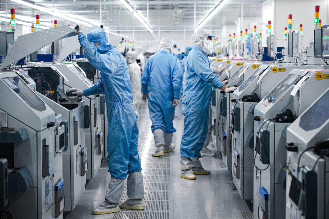 Technicians work on chip-processing equipment at a semiconductor plant in Suqian, Jiangsu Province, China, on Oct. 20, 2025. Trump has ruled out selling Nvidia’s most advanced chips to China, while Beijing has barred foreign semiconductors from state-funded data centers. (STR/AFP via Getty Images)