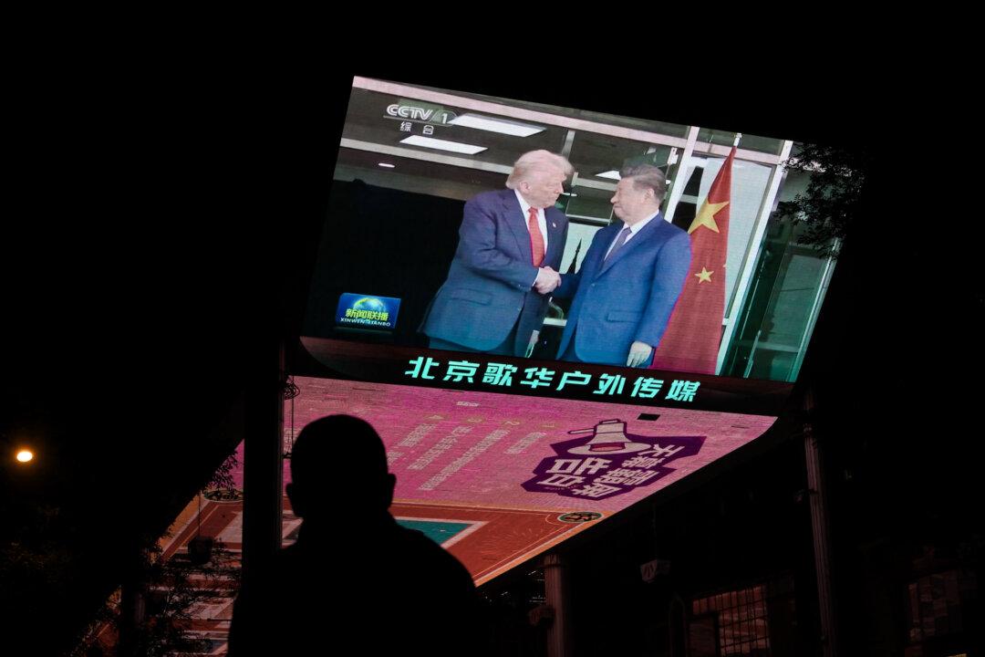 News coverage of the meeting between U.S. President Donald Trump and Chinese leader Xi Jinping in South Korea is shown on a television outside a shopping mall in Beijing on Oct. 30, 2025. The two leaders agreed to pause China's reciprocal tariffs, resume Chinese purchases of U.S. soybeans, temporarily lift rare-earth export controls, and curb fentanyl precursor smuggling. (Adek Berry/AFP via Getty Images)