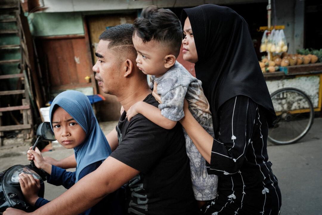 A family rides on a motor scooter in Jakarta, Indonesia, on Nov. 8, 2025. (Yasuyoshi Chiba/AFP via Getty Images)