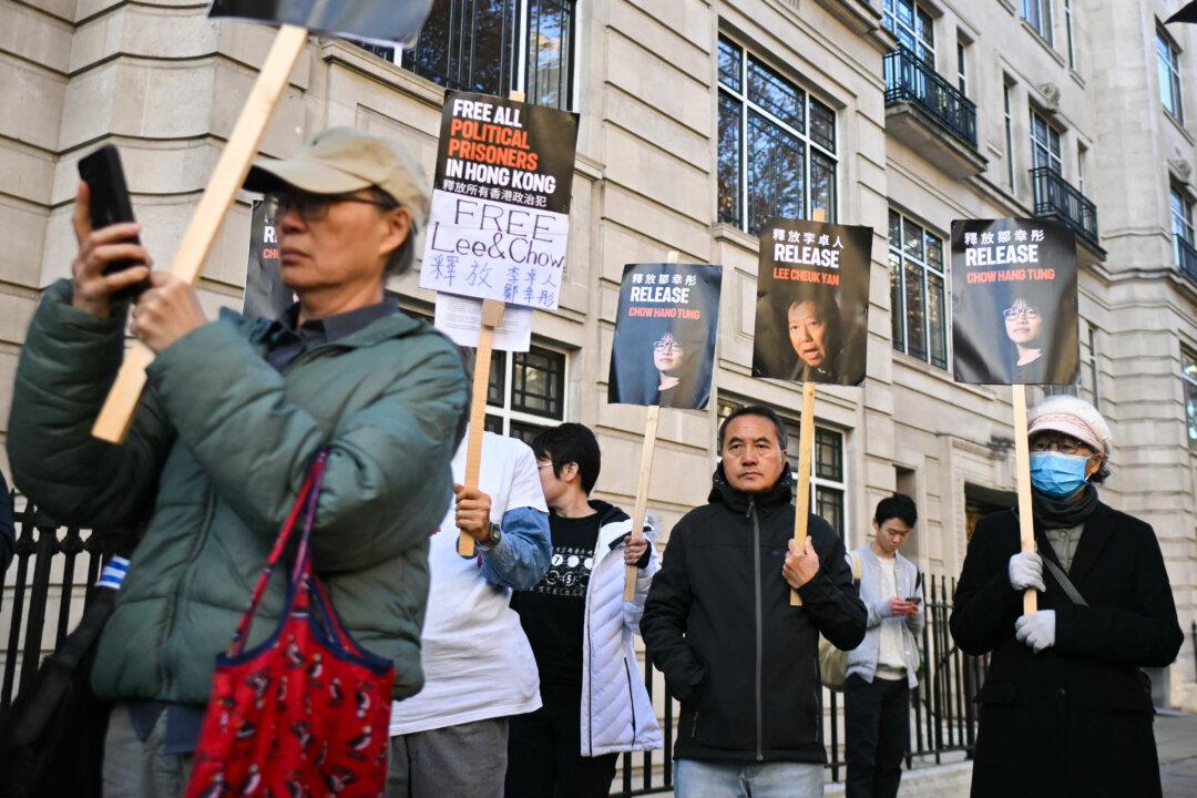 Protesters hold placards as they gather for a “solidarity action” outside the Chinese Embassy in London, on Nov. 8, 2025, in support of the Hong Kong Alliance defendants. A Hong Kong court ruled last week that it will go ahead with the national security trial of three democracy activists, leaders of the now-disbanded Tiananmen Square massacre vigil organizer group known as the Hong Kong Alliance, in January, rejecting a last-ditch application to toss out the case. (Justin Tallis/AFP via Getty Images)