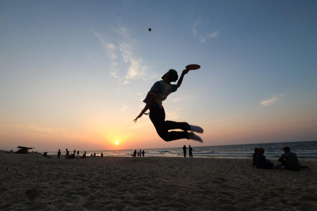 Displaced Palestinians spend time on the beach opposite their tent shelters stretched along the Nuseirat beach road in the central Gaza Strip, on Nov. 8, 2025. (Eyad Baba/AFP via Getty Images)