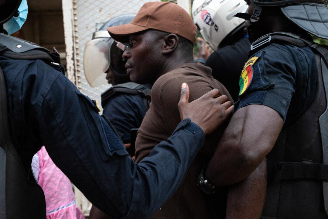 Police officers detain a protester in the Sacré-Cur 3 neighborhood during a banned demonstration by Senegal's opposition, on Nov. 8, 2025. The protest coincides with Senegal's Prime Minister Ousmane Sonko calling on his supporters to rally in Dakar on the same day. (Seyllou/AFP via Getty Images)