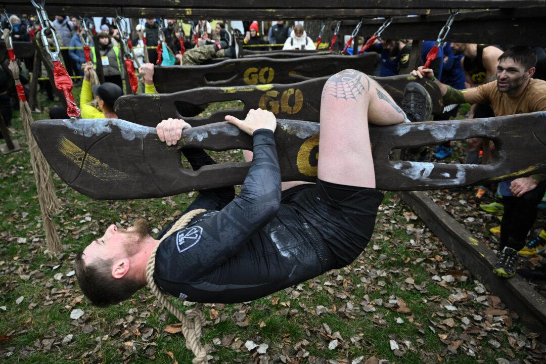 Ukrainian military personnel participate in the Dyka Gonka (Wild Race) competition run in Kyiv, on Nov. 8, 2025. The Dyka Gonka, in which military personnel, professional athletes, and amateurs took part, combined various types of activities—running across rough terrain, overcoming obstacles, and battling the challenges of nature on distances of 200 meters, 1.6 kilometers, and 5 kilometers. (Genya Savilov/AFP via Getty Images)
