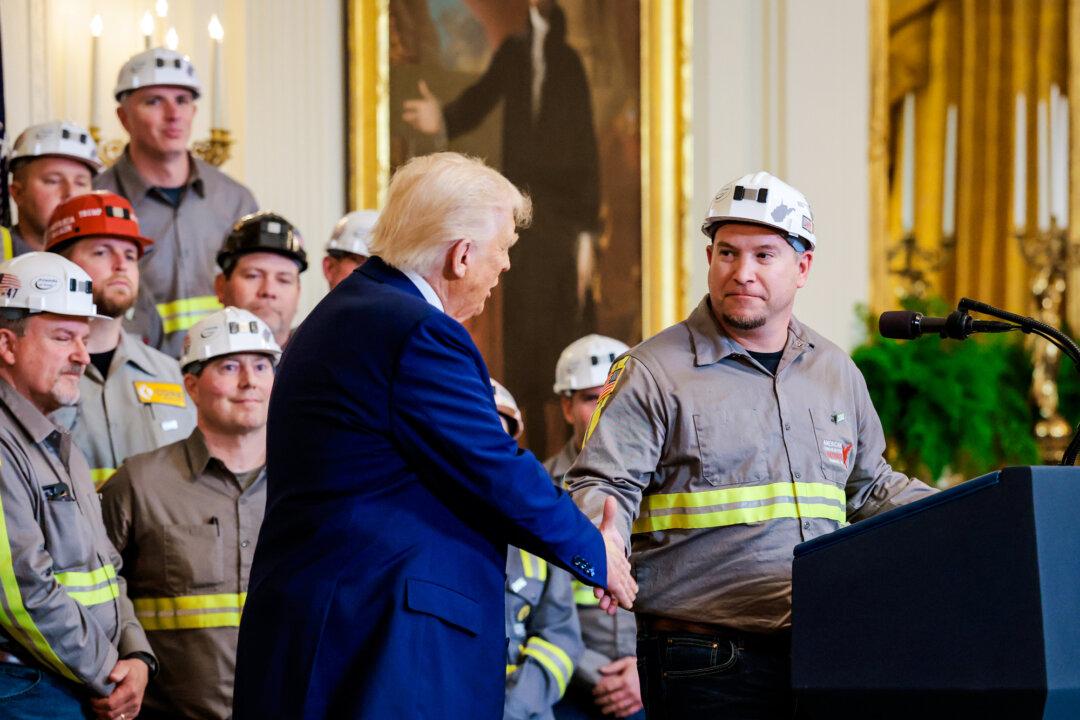 President Donald Trump shakes hands with coal miner Jeff Crowe at an executive order signing ceremony at the White House on April 8, 2025. Since taking office in January, Trump has also expanded government involvement in sectors critical for U.S. national security, a significant shift in industrial policy. (Anna Moneymaker/Getty Images)
