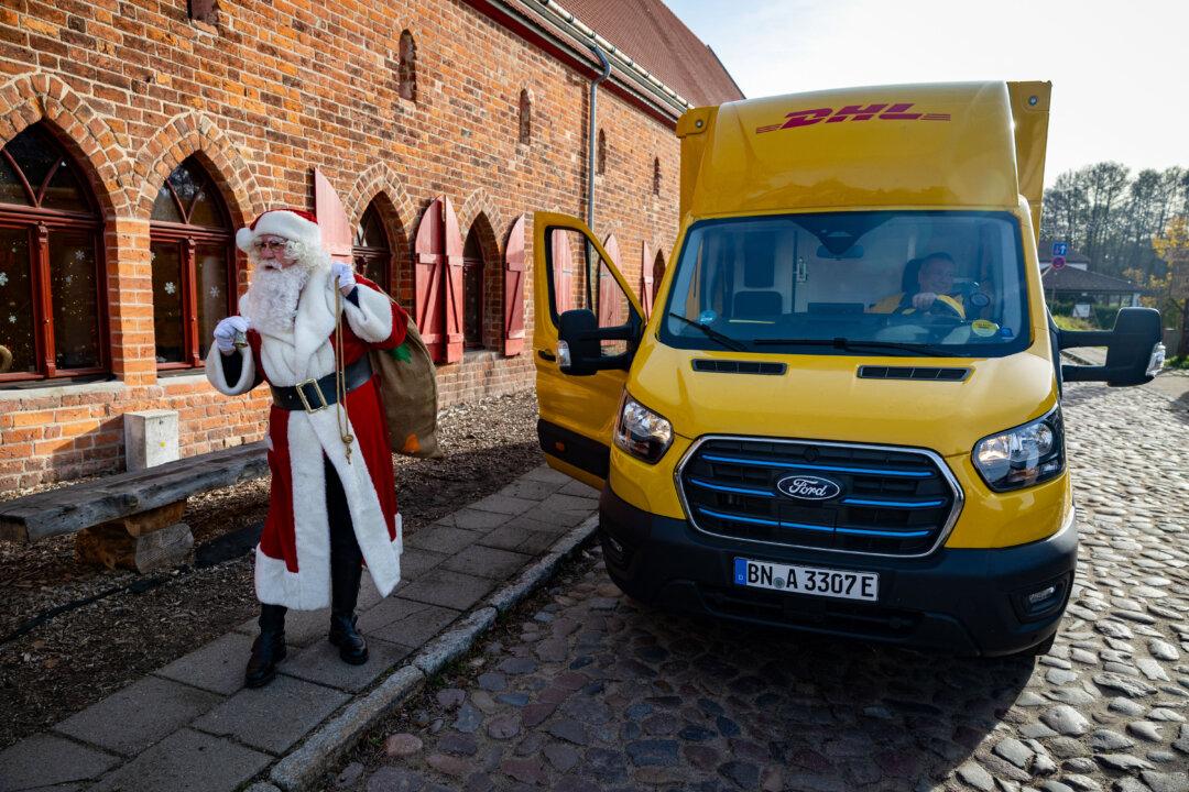 A man dressed as Santa Claus arrives in a truck of multinational courier company DHL during the season opening of the traditional Christmas post office in the village of Himmelpfort, Germany, on Nov. 13, 2025. (Odd Andersen/AFP via Getty Images)