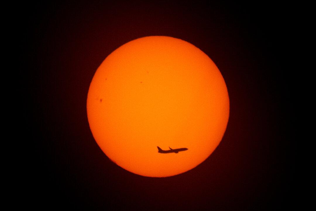 An aircraft flies at sunrise in Buenos Aires, Argentina, on Nov. 13, 2025. (Luis Robayo/AFP via Getty Images)