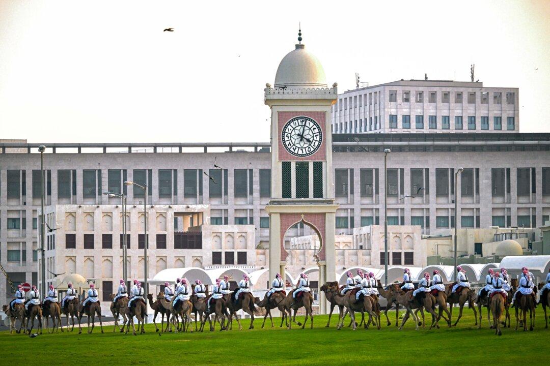 Camel-mounted royal guards patrol around the Amiri Diwan in Doha, Qatar, on Nov. 13, 2025. (Mahmud Hams/AFP via Getty Images)
