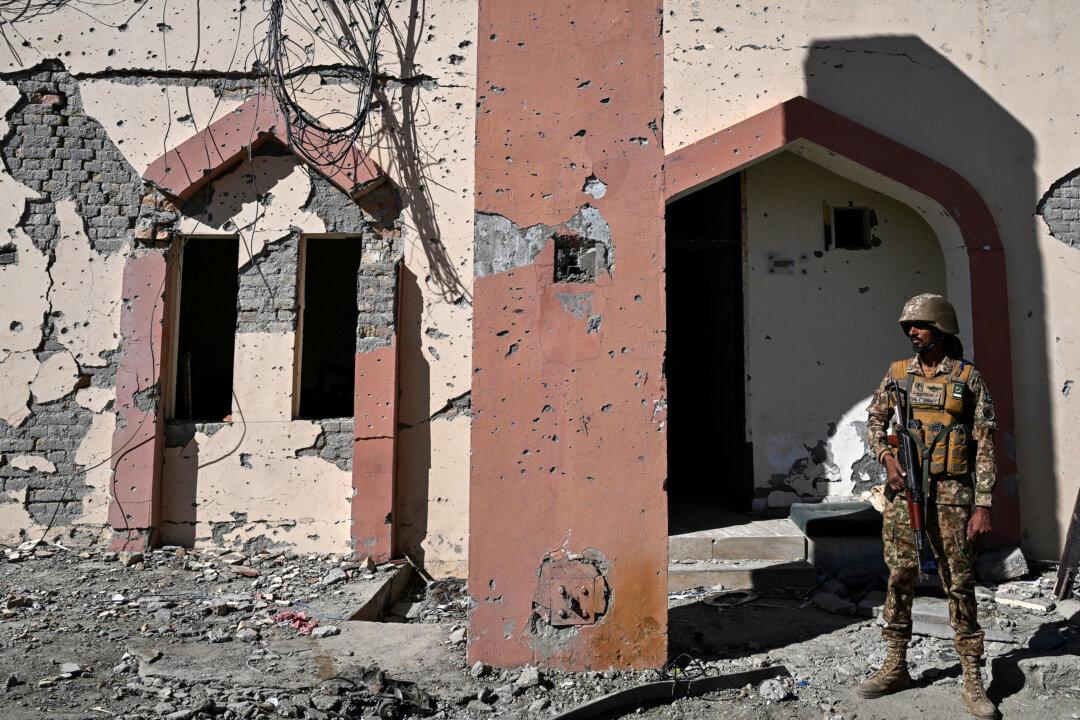 A member of the Pakistan military stands at the damaged entrance after an attack on the Cadet College Wana, a military-linked school, in the South Waziristan district near the Pakistan-Afghanistan border, on Nov. 13, 2025. (Aamir Qureshi/AFP via Getty Images)