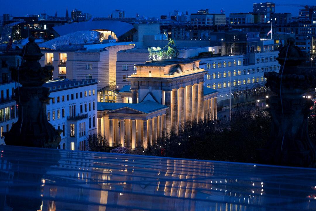 The landmark Brandenburg Gate, seen from the Reichstag building, is illuminated in Berlin, on Nov. 13, 2025. (Ralf Hirschberger/AFP via Getty Images)
