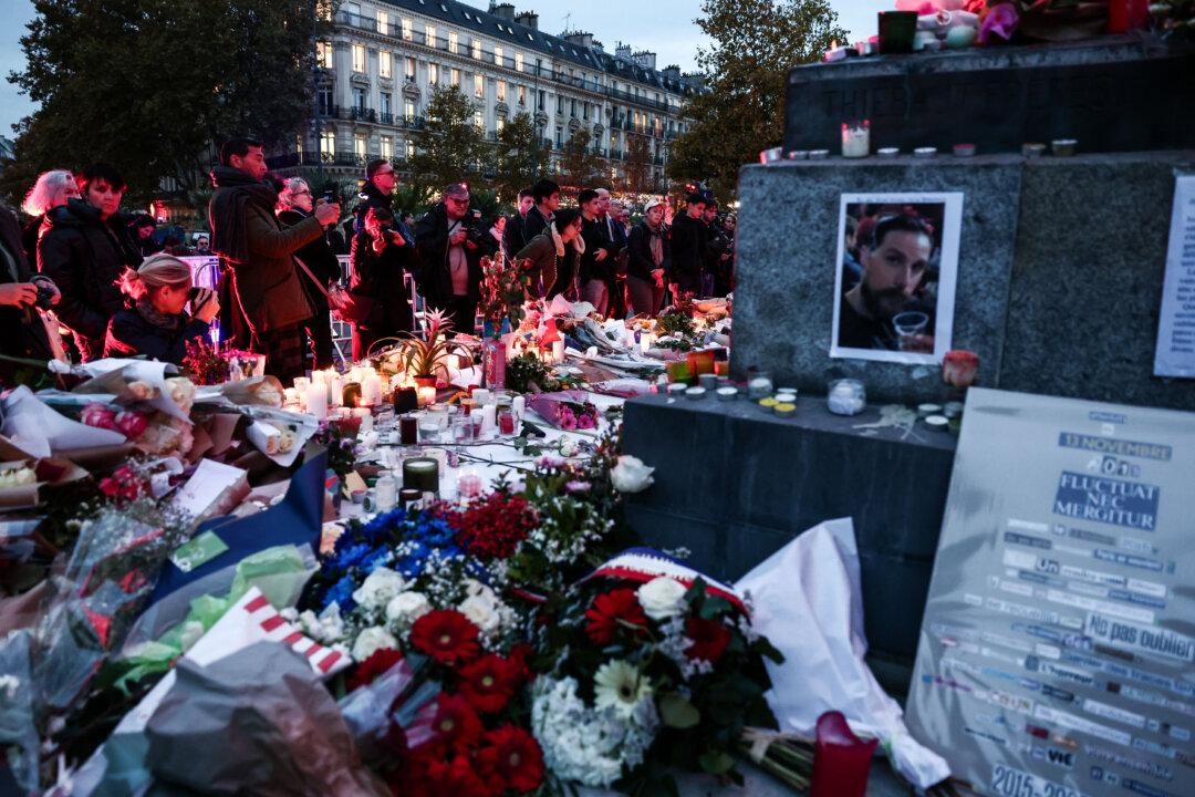 People gather in front of a makeshift memorial at Place de la Republique in Paris, on Nov. 13, 2025, during the anniversary marking a decade since the series of terror attacks of Nov. 13, 2015, in which 130 civilians were killed at cafes, the soccer stadium, and Bataclan concert hall. (Thibaud Moritz/AFP via Getty Images)