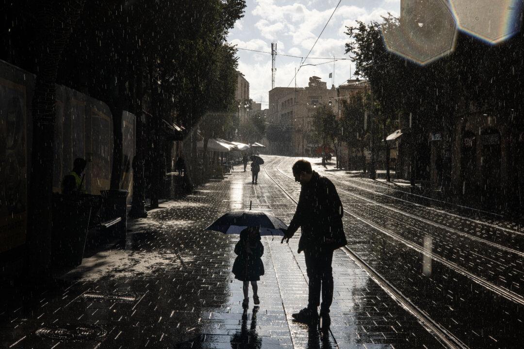 A girl walks with an umbrella during the season’s first rainfall in Jerusalem on Nov. 14, 2025. (John Wessels/AFP via Getty Images)