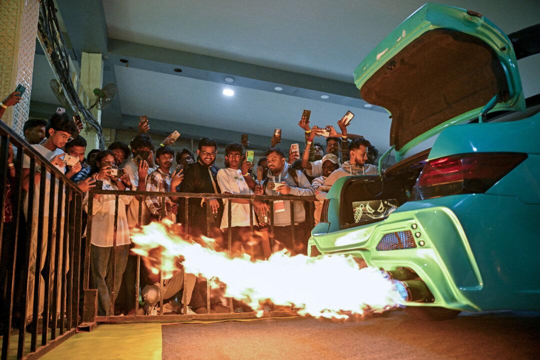 Visitors inspect the exhaust system of a modified Honda City during the 4th International Autoshow at Palace Grounds in Bengaluru, India, on Nov. 14, 2025. (Idrees Mohammed/AFP via Getty Images)