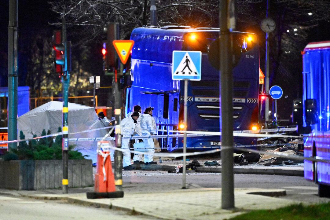 Police forensic officers work at the site of a bus crash that struck pedestrians in the Östermalm district of Stockholm, Sweden, on Nov. 14, 2025. Several people were killed and others injured. (Claudio Bresciani/TT News Agency/AFP via Getty Images)