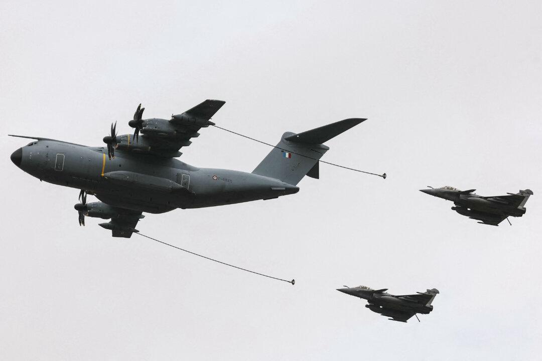 Two Dassault Rafale fighter jets refuel from a French Air Force A400M during the Taranis military exercise at Orléans-Bricy air base in Boulay-les-Barres, France, on Nov. 14, 2025. The drill tests high-intensity air-and-space operations. (Thomas Samson/AFP via Getty Images)