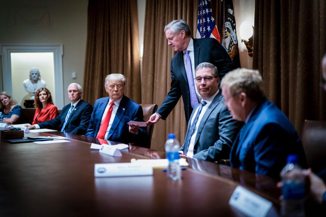 White House Chief of Staff Mark Meadows hands President Donald Trump a note during a meeting at the White House on Aug. 3, 2020. Meadows is among more than 400 Republican organizations and individuals targeted in “Arctic Frost,” which involved nearly 200 secret subpoenas for documents, financial records, and communications spanning years. (Doug Mills-Pool/Getty Images)