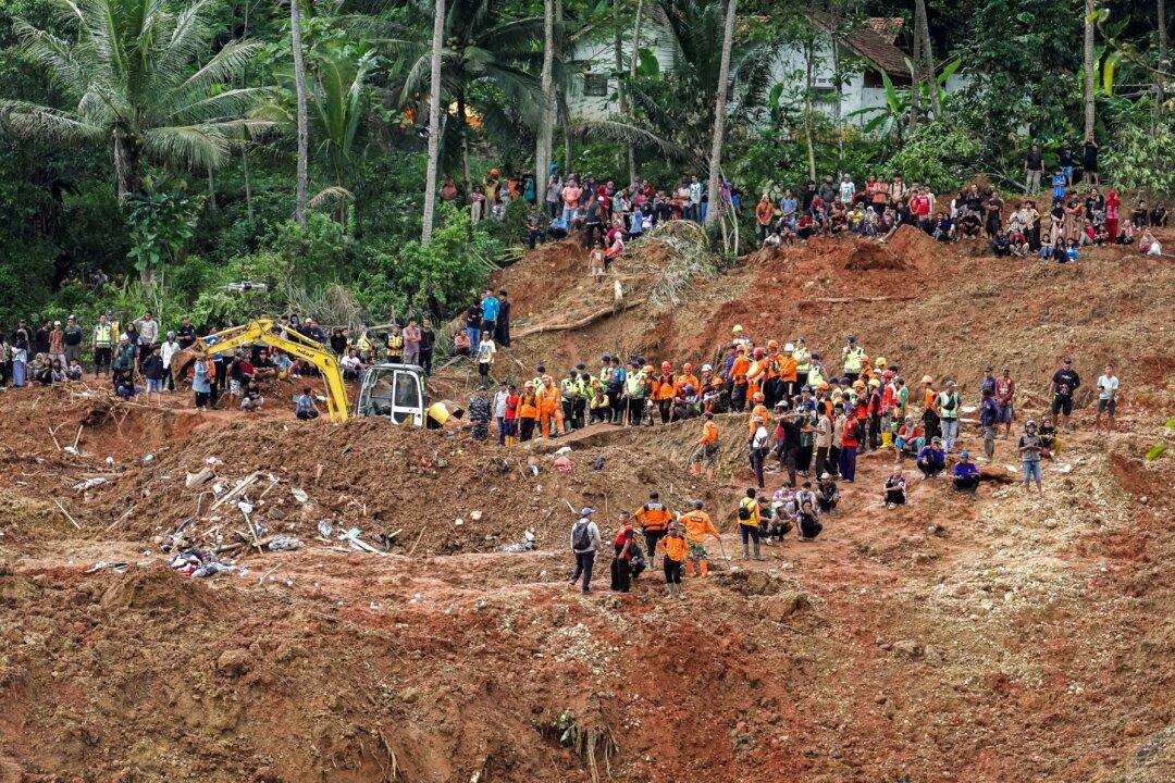 Indonesian rescue members search for victims at the site of a landslide, which hit Cibeunying village on Nov. 13, in Cilacap, Central Java province, Indonesia, on Nov. 15, 2025. (Reuters/Stringer)