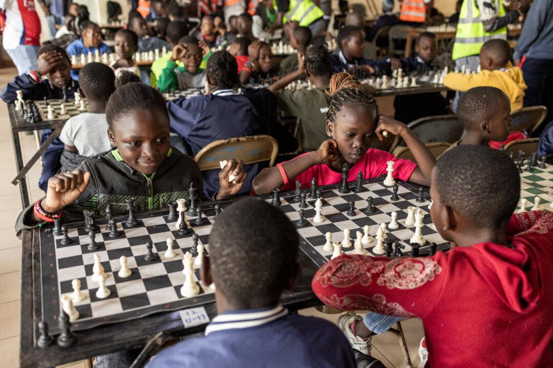 A young chess player reacts as she takes part in the Kibera Chess Tournament in Kibera, Nairobi, on Nov. 15, 2025. The tournament brought together 195 children from different informal settlements, with the aim of nurturing young minds, strengthening critical thinking, and inspiring the next generation. (Simon Maina/AFP via Getty Images)