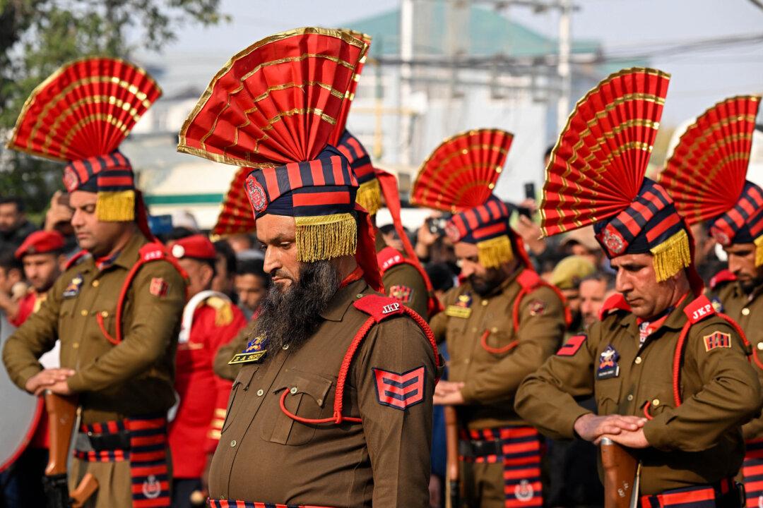 Security forces stand guard around coffins during the wreath-laying ceremony for the deceased victims in an accidental blast at Nowgam police station, on the outskirts of Srinagar, India, on Nov. 15, 2025. (Tauseef Mustafa/AFP via Getty Images)