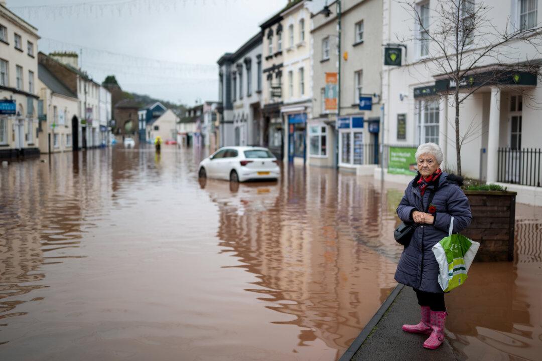 A woman looks on at a flooded Monnow Street in Monmouth, Wales, United Kingdom, on Nov. 15, 2025. Storm Claudia caused severe and widespread flooding in Monmouth and has been declared a major incident by South Wales Fire and Rescue Service. (Matthew Horwood/Getty Images)