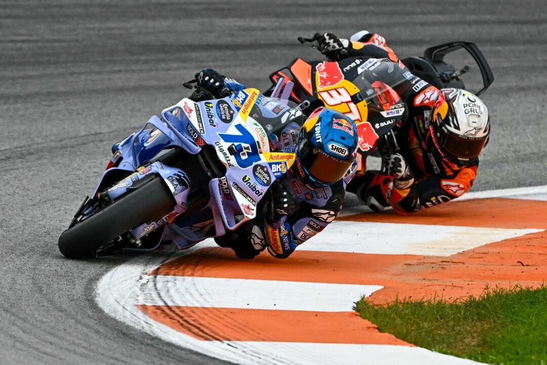 BK8 Gresini Racing MotoGP team's Spanish MotoGP rider Alex Marquez (L) rides in front of Red Bull KTM Factory Racing team's Spanish MotoGP rider Pedro Acosta during the sprint race ahead of the MotoGP Valencia Grand Prix at the Ricardo Tormo racetrack in Cheste, Spain, on Nov. 15, 2025. (Jose Jordan/AFP via Getty Images)