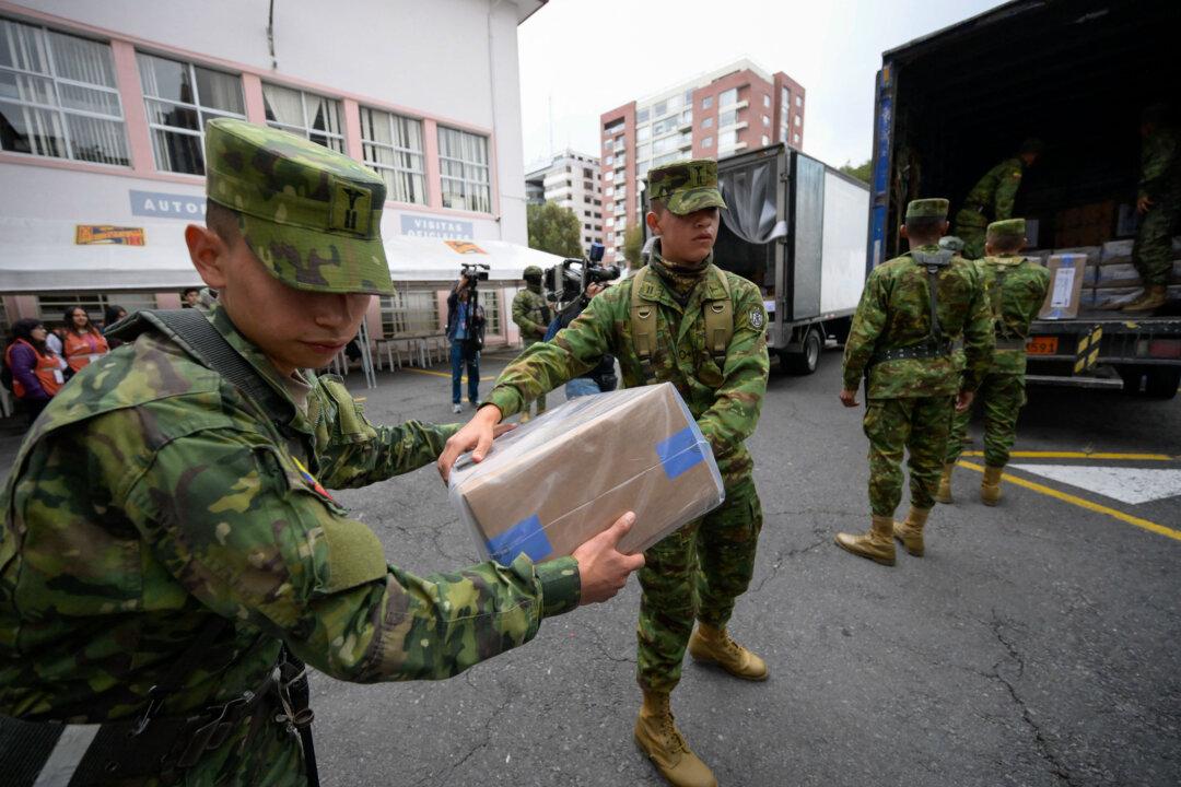 Members of the Ecuadorian Army hold electoral materials for the referendum vote at a school in the north of Quito on Nov. 15, 2025. Ecuadoreans head to the polls on Nov. 16 to vote in a referendum proposed by President Daniel Noboa on whether to allow the return of foreign military bases, draft a new constitution that could expand presidential powers, eliminate public funding for political parties, and reduce the number of lawmakers. (Rodrigo Buendia/AFP via Getty Images)