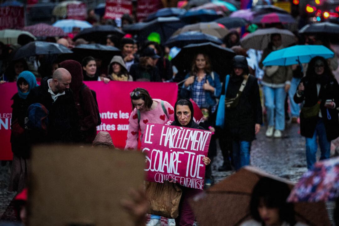 A protester holds a banner reading “School bullying kills” during a march to denounce violence against children and teenagers, ahead of International Children's Rights Day, which is celebrated on Nov. 20, in Paris, on Nov. 15, 2025. (Dimitar Dilkoff/AFP via Getty Images)