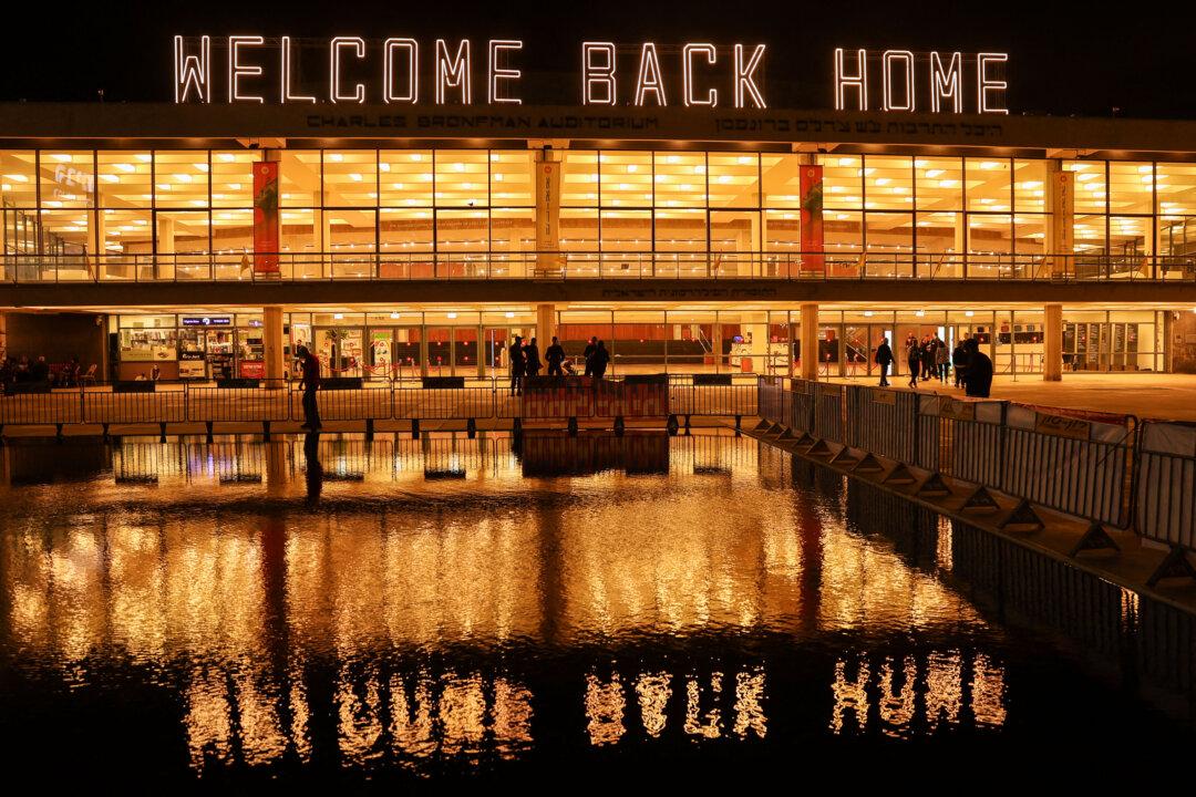 A photograph shows Tel Aviv's Culture Centre with the words “Welcome back home” displayed on its roof, referring to the hostages held in Gaza and returned by the Hamas terrorist group, ahead of a demonstration against the Israeli prime minister and in support of establishing a state commission of inquiry into Hamas's Oct. 7, 2023, attacks on Israel, on Habima Square in Tel Aviv, on Nov. 15, 2025. (Jack Guez/AFP via Getty Images)