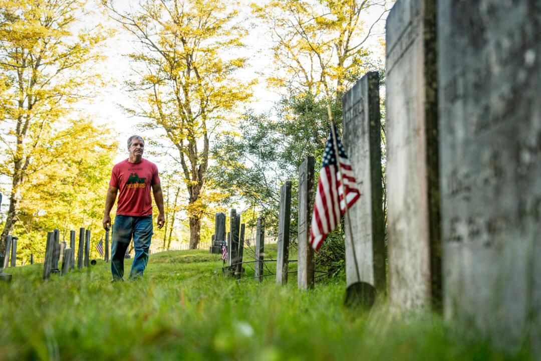 Farmer and lawyer John Klar walks through the family cemetery near his homestead in Brookfield, Vt., on Sept. 12, 2025. Klar returned to the Green Mountains of Vermont in the late 1990s to buy a property surrounded by farmland that his mother’s family worked for generations. (Samira Bouaou/The Epoch Times)