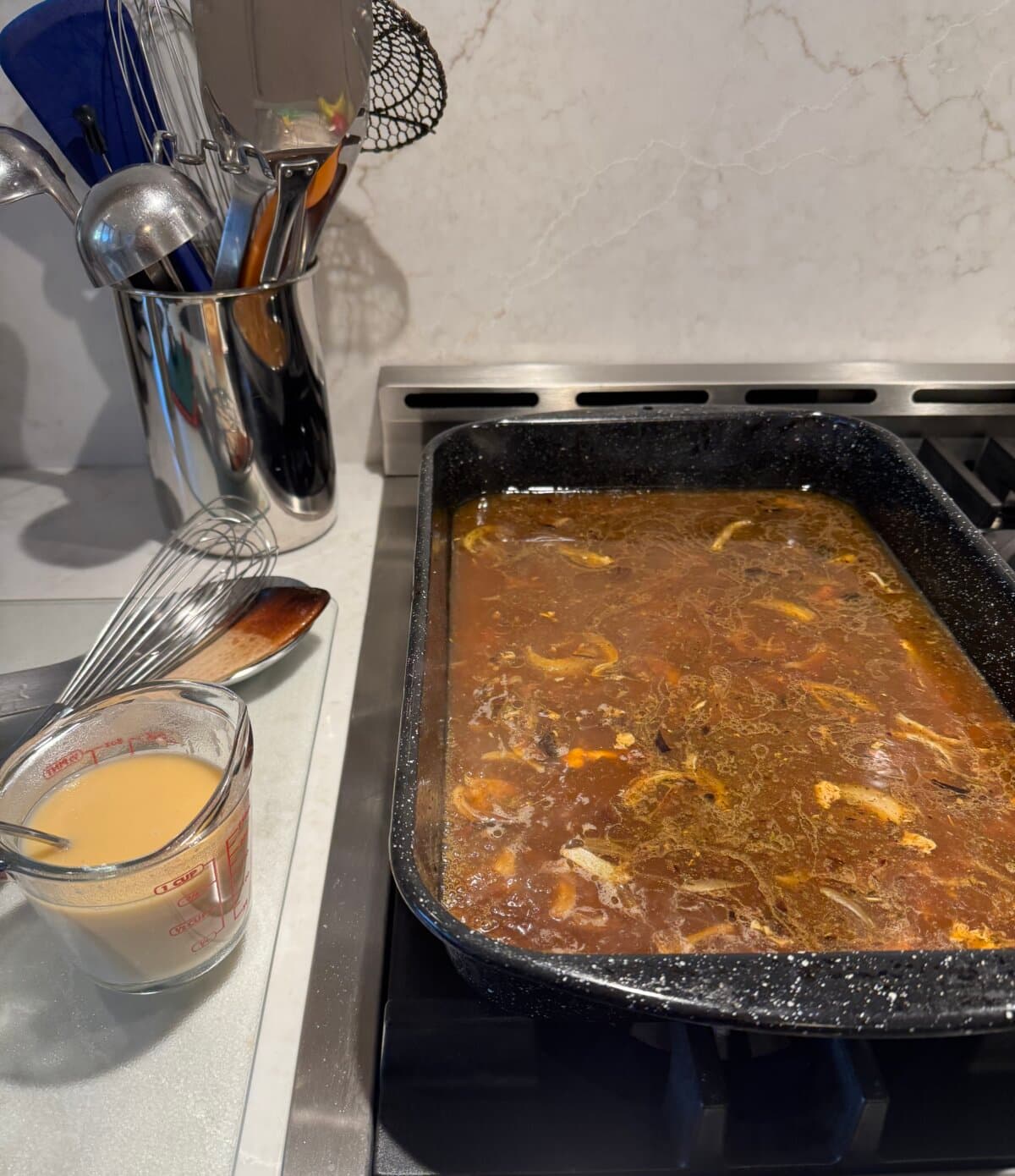 The drip pan beneath the roasted turkey holds concentrated flavor and forms the foundation for superior gravy. (JeanMarie Brownson/TCA)
