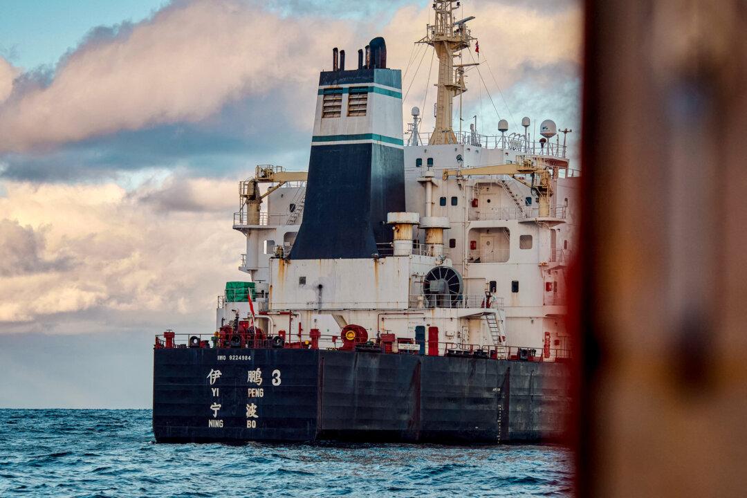 The bulk carrier Chinese ship Yi Peng 3 is anchored and being monitored by a Danish naval patrol vessel in the sea of Kattegat, Denmark, on Nov. 20, 2024. Denmark's navy said on Nov. 20, 2024, that it was shadowing a Chinese cargo vessel in the Baltic Sea, a day after Finland and Sweden opened investigations into the suspected sabotage of two severed undersea telecoms cables. (Mikkel Berg Pedersen/Ritzau Scanpix/AFP via Getty Images)