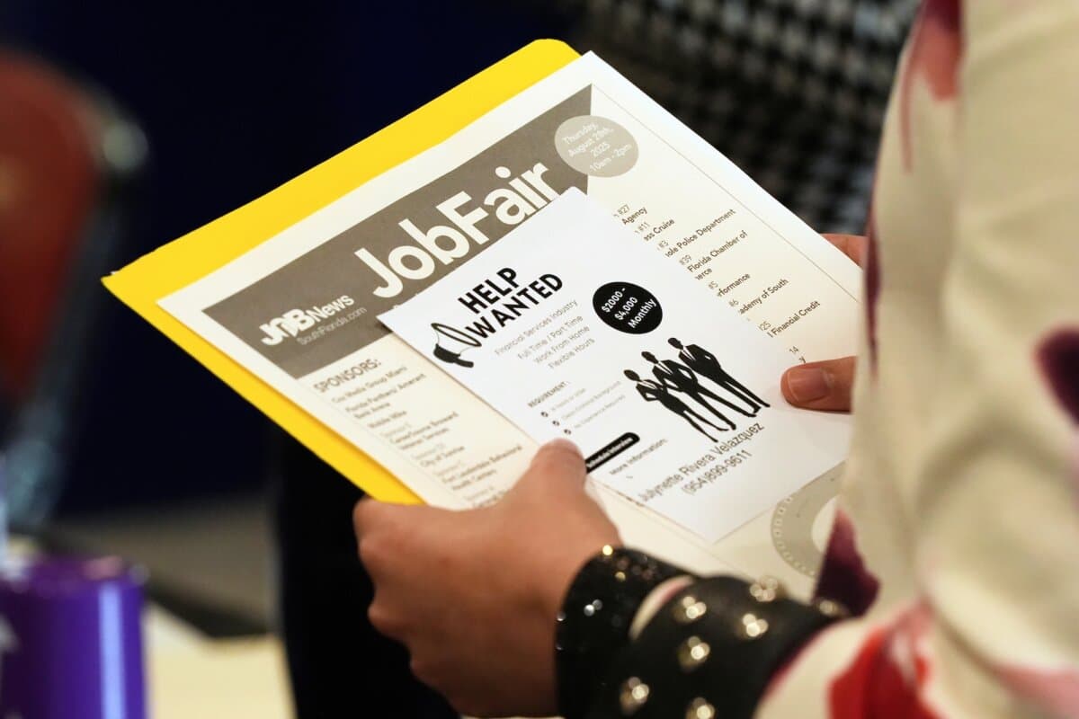 A job seeker waits to talk to a recruiter at a job fair in Sunrise, Fla., on Aug. 28, 2025. (AP Photo/Marta Lavandier, File)