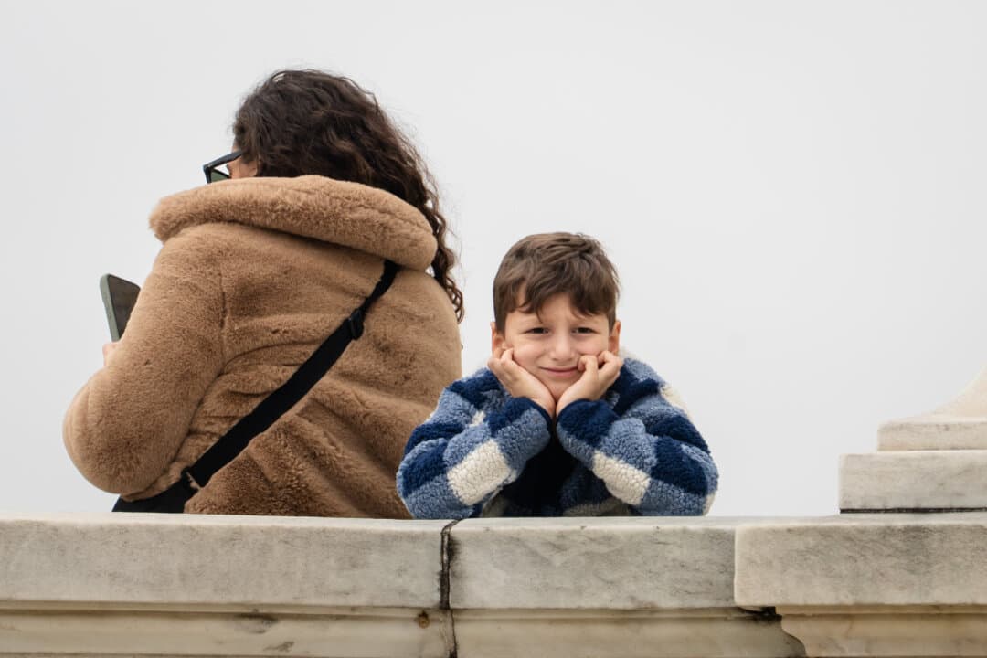 A youngster watches the arrival of the 2025 U.S. Capitol Christmas Tree in Washington on Nov. 21, 2025. (Madalina Kilroy/The Epoch Times)