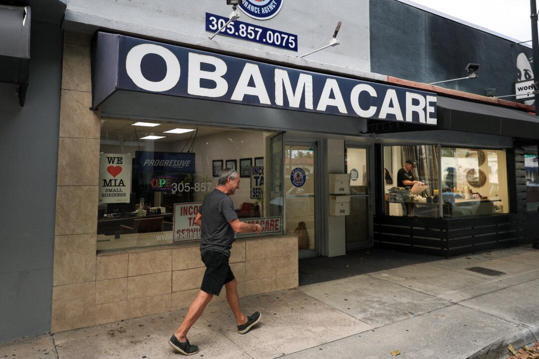 An Obamacare sign is displayed outside an insurance agency in Miami on Nov. 12, 2025. Data show enrollment has surged since enhanced tax credits began in 2021, roughly doubling over five years. (Joe Raedle/Getty Images)