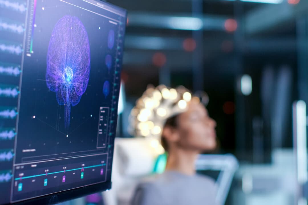 Woman Wearing Brainwave Scanning Headset In the Brain Study Laboratory. (Gorodenkoff/Shutterstock)
