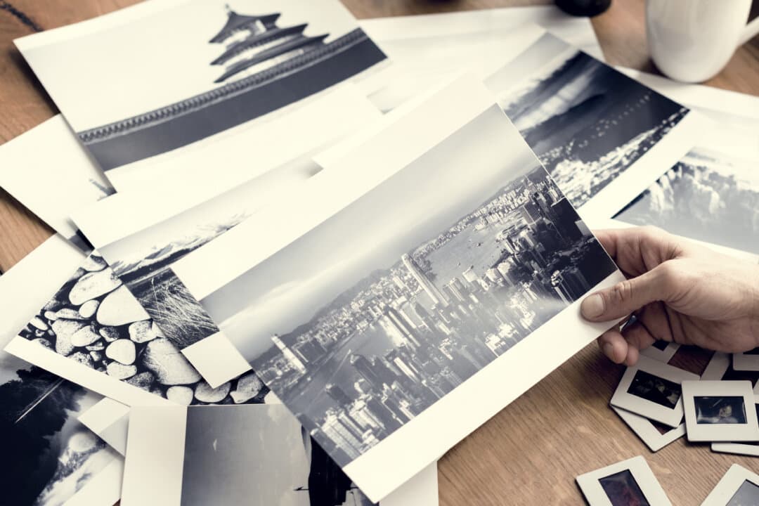 A man looks at old photographs. (Rawpixel.com/Shutterstock)