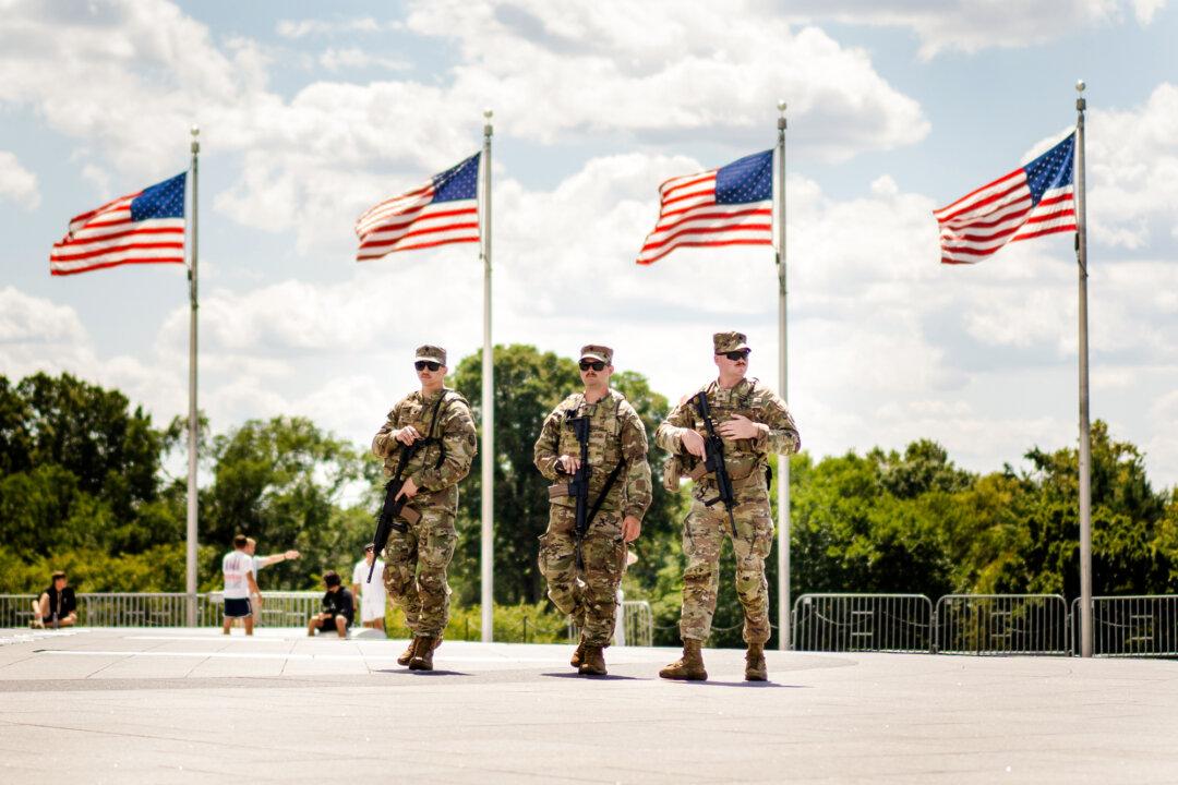 National Guard members patrol the National Mall in Washington on Aug. 27, 2025. On Nov. 20, Judge Jia Cobb of the U.S. District Court for the District of Columbia ordered the president to end the troop deployment, ruling that he may deploy troops for only a specific situation, not “whatever reason” he chooses. She then stayed her order to give the government time to appeal. (Madalina Kilroy/The Epoch Times)