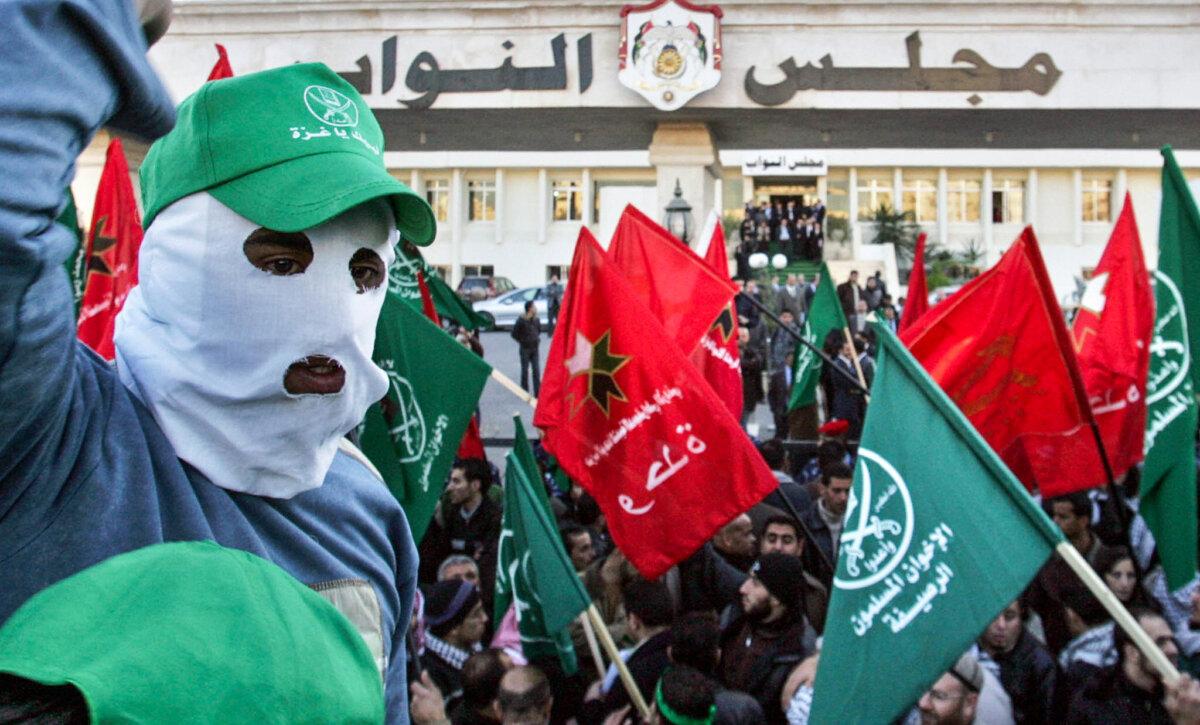 Jordanian demonstrators waving green Muslim Brotherhood flags and other banners shout anti-Israel slogans during a mass rally held outside the parliament building in Amman, Jordan, in this file photo. (Khalil Mazraawi/AFP via Getty Images)