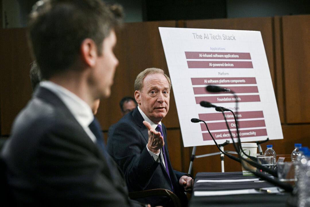 Microsoft Vice Chair and President Brad Smith (R) and OpenAI CEO Sam Altman speak during a Senate Commerce Committee hearing on artificial intelligence in Washington on May 8, 2025. (Brendan Smialowski/AFP via Getty Images)