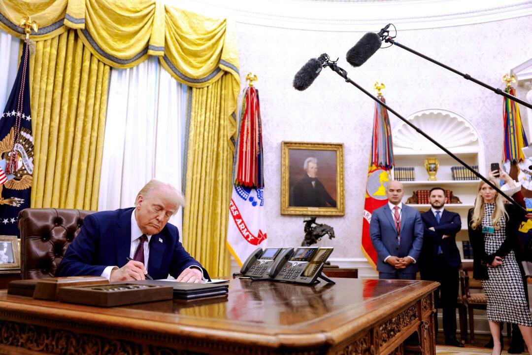 President Donald Trump signs executive orders in the Oval Office on Jan. 23, 2025. Shortly after taking office, Trump signed an order barring federal funding toward, or promotion of, gender-transition medical interventions for minors. (Anna Moneymaker/Getty Images)