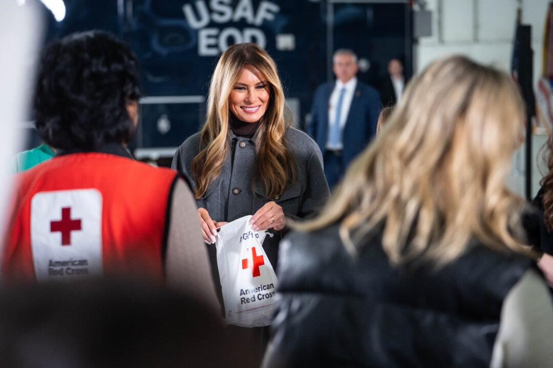 First Lady Melania Trump speaks with guests during a Red Cross holiday care package-building and card-writing event at Joint Base Andrews, Md., on Dec. 1, 2025. (Madalina Kilroy/The Epoch Times)
