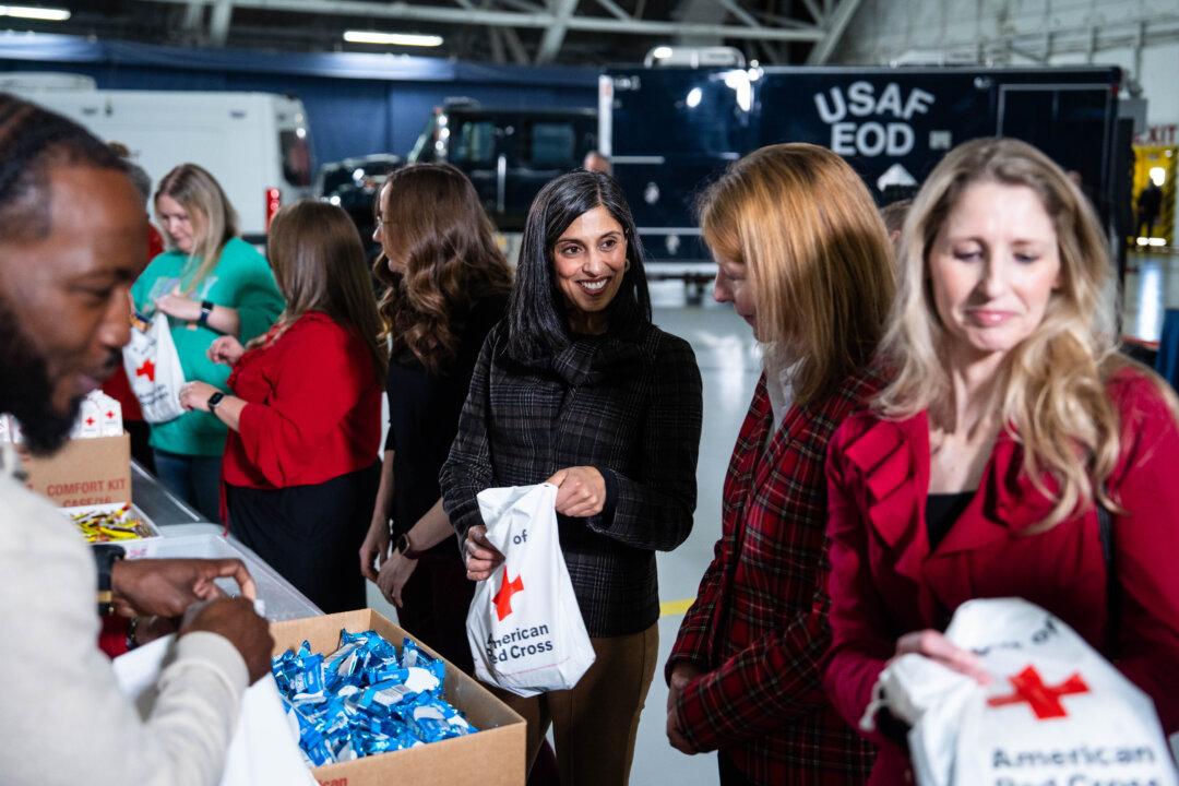Second Lady Usha Vance speaks with guests during the Red Cross holiday care package–building and card-writing event at Joint Base Andrews, Md., on Dec. 1, 2025. (Madalina Kilroy/The Epoch Times)