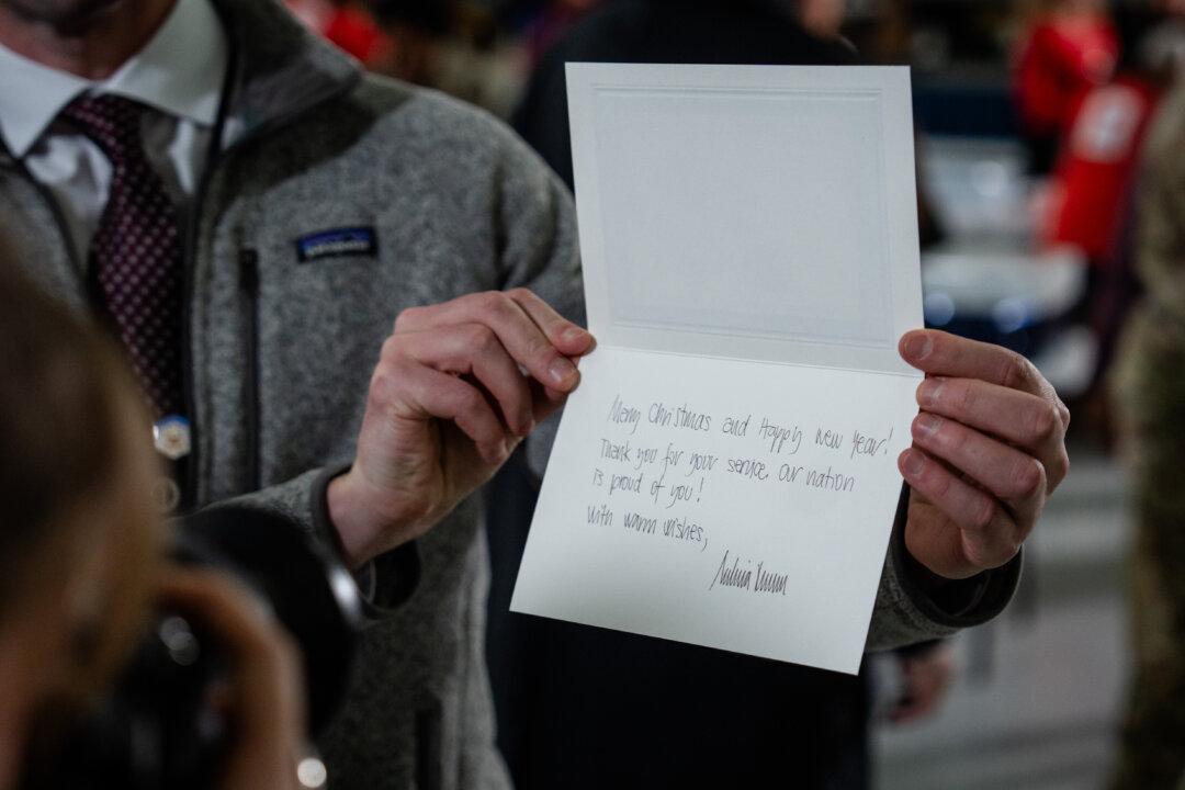 A card written by First Lady Melania Trump during the Red Cross holiday care package-building and card-writing event at Joint Base Andrews, Md., on Dec. 1, 2025. (Madalina Kilroy/The Epoch Times)
